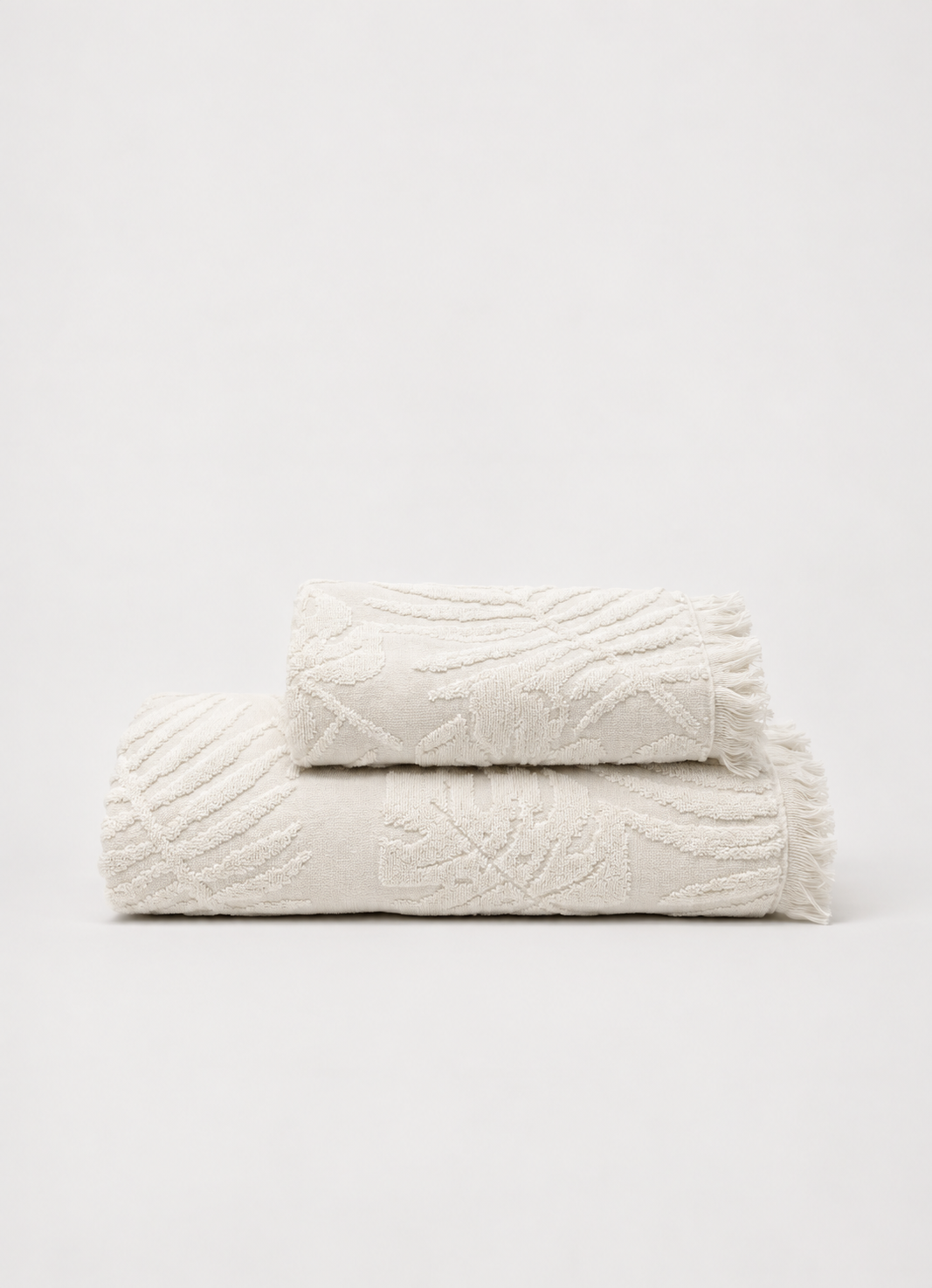 Laurier Botanical Towel in Cloud White — Turkish cotton bath and hand towel with raised botanical texture and fringed edge, folded