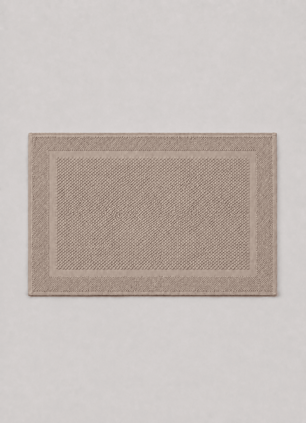 Haven bath mat in Warm Pebble — hero shot of richly woven Turkish cotton with raised detailing