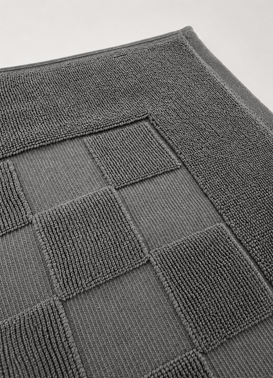 Marlow Check bath mat in Deep Slate — detail of check pattern and raised border