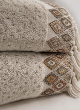 Close-up of the Santa Fe towel's raised textured weave in Soft Sand — Calinea