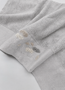 Florence Heirloom towel in Mist Grey — close-up of smooth Turkish cotton weave and embroidery detail