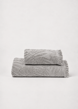Laurier Botanical Towel in Mist Stone — Turkish cotton bath and hand towel with raised botanical texture and fringed edge, folded