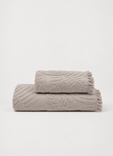 Laurier Botanical Towel in Oat Taupe — Turkish cotton bath and hand towel with raised botanical texture and fringed edge, folded
