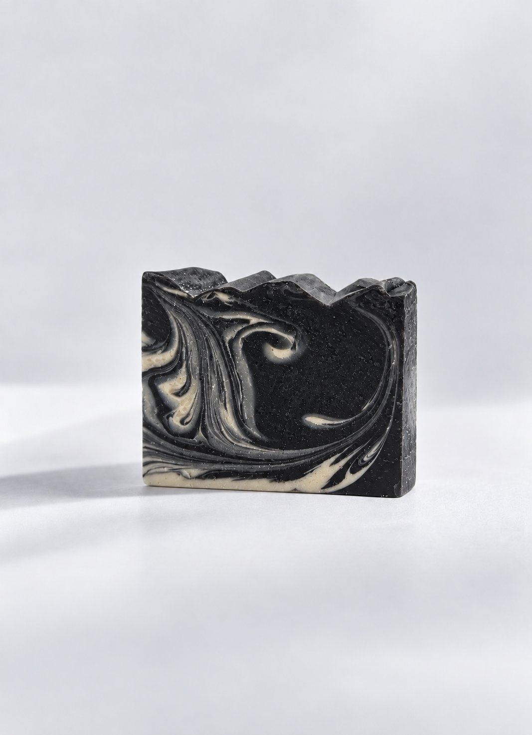 Calinea Botanical Soap Bar in Activated Charcoal & Goat Milk — a deep charcoal cold-process bar marbled with cream, handmade in Türkiye