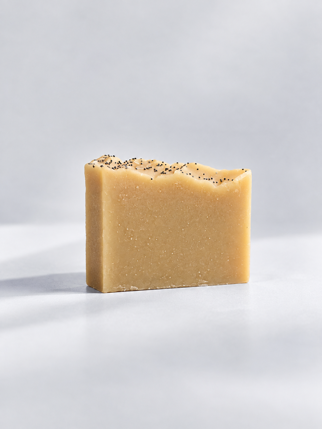 Calinea Botanical Soap Bar in Donkey Milk — a smooth ivory cold-process bar topped with poppy seed, handmade in Türkiye
