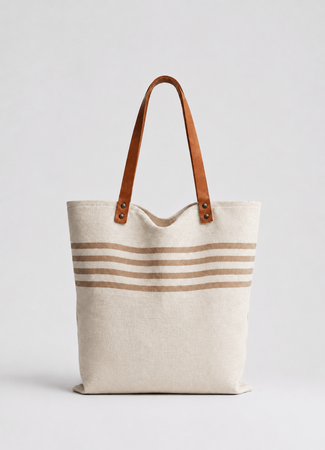 Linen beach tote in Cream — hero shot of spacious striped linen bag with faux leather straps