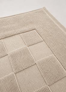 Marlow Check bath mat in Alabaster — lifestyle shot in bathroom setting