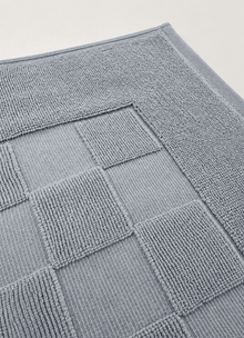 Marlow Check bath mat in Coastal Slate — lifestyle shot in styled bathroom