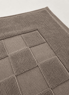Marlow Check bath mat in Smoke — lifestyle shot in styled bathroom