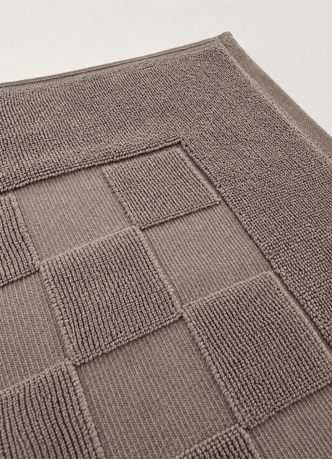 Marlow Check bath mat in Smoke — lifestyle shot in styled bathroom