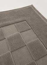Marlow Check bath mat in Smoke — lifestyle shot in styled bathroom