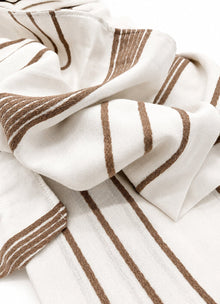 Silken lyocell bedding set in Sand Line — lifestyle shot in styled bedroom